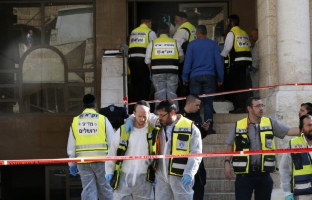 Israeli emergency personnel stand at the scene of an attack at a Jerusalem synagogue