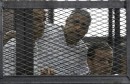 658815-peter-greste-mohamed-fahmy-and-baher-mohamed-listen-to-the-ruling-at-a-co
