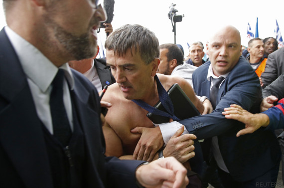 Xavier Broseta, Executive Vice President for Human Resources and Labour Relations at Air France, is evacuated by security after employees interrupted a meeting at the Air France headquarters building in Roissy